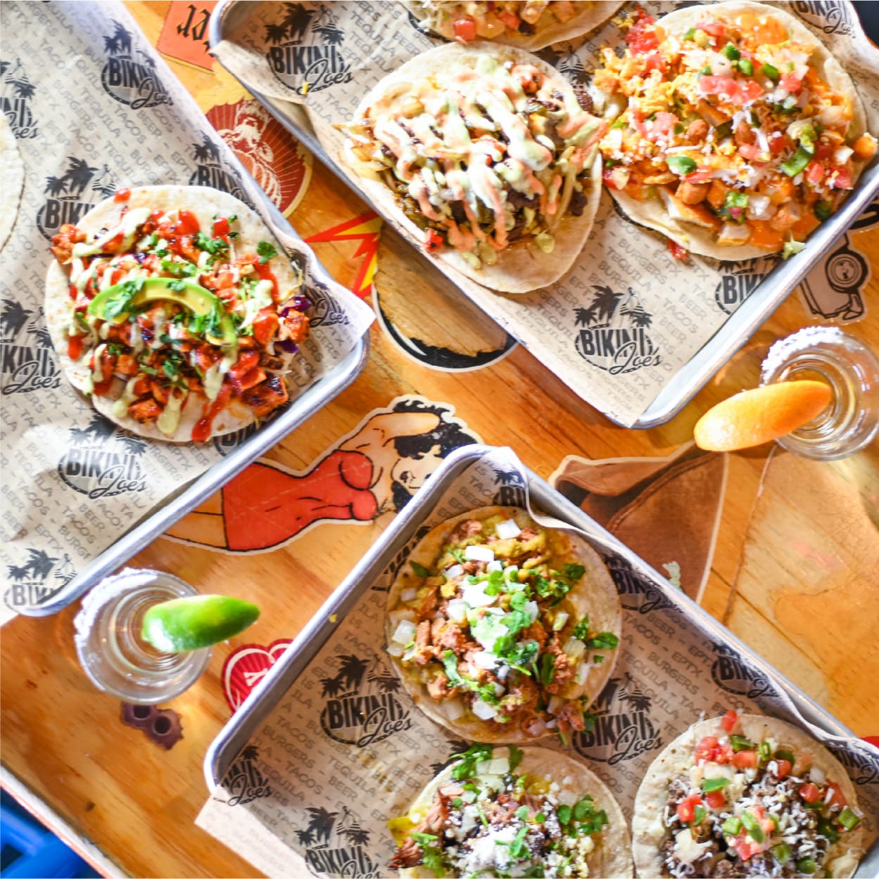 Overhead view of fresh street tacos and tequila shots at Cabo Joe's