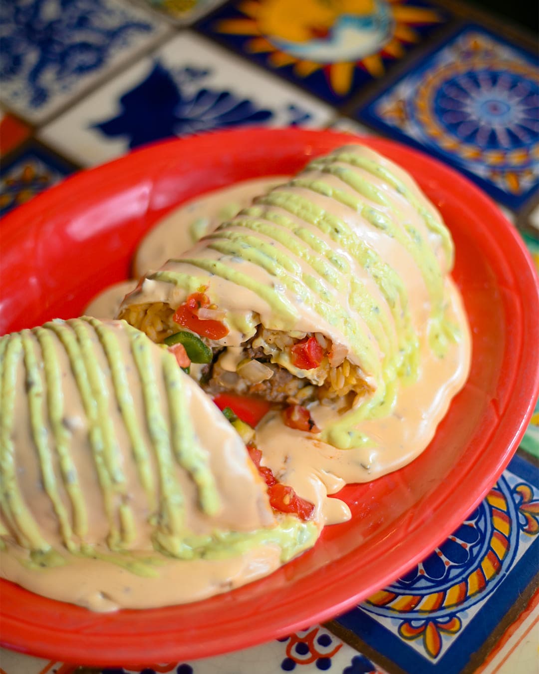 Burrito smothered in queso and avocado ranch at Cabo Joe's