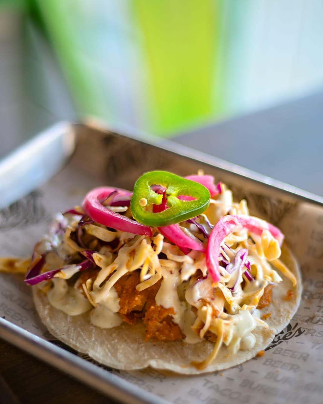 Crispy fish taco with slaw, pickled onion, and jalapeño at Cabo Joe's