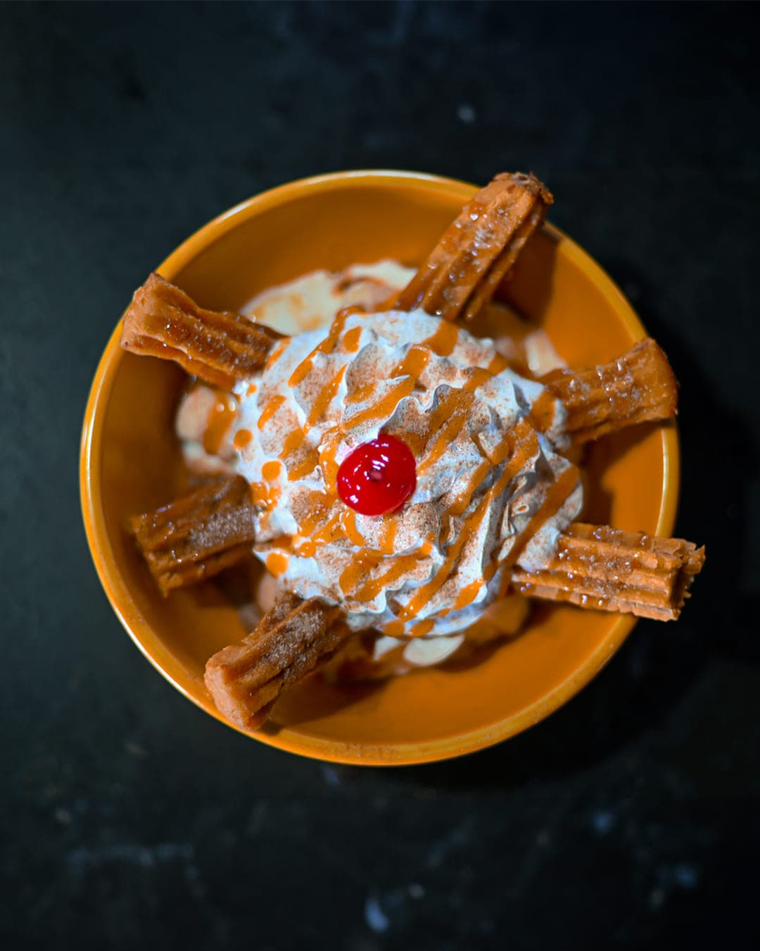 Churro sundae with whipped cream and a cherry at Cabo Joe's