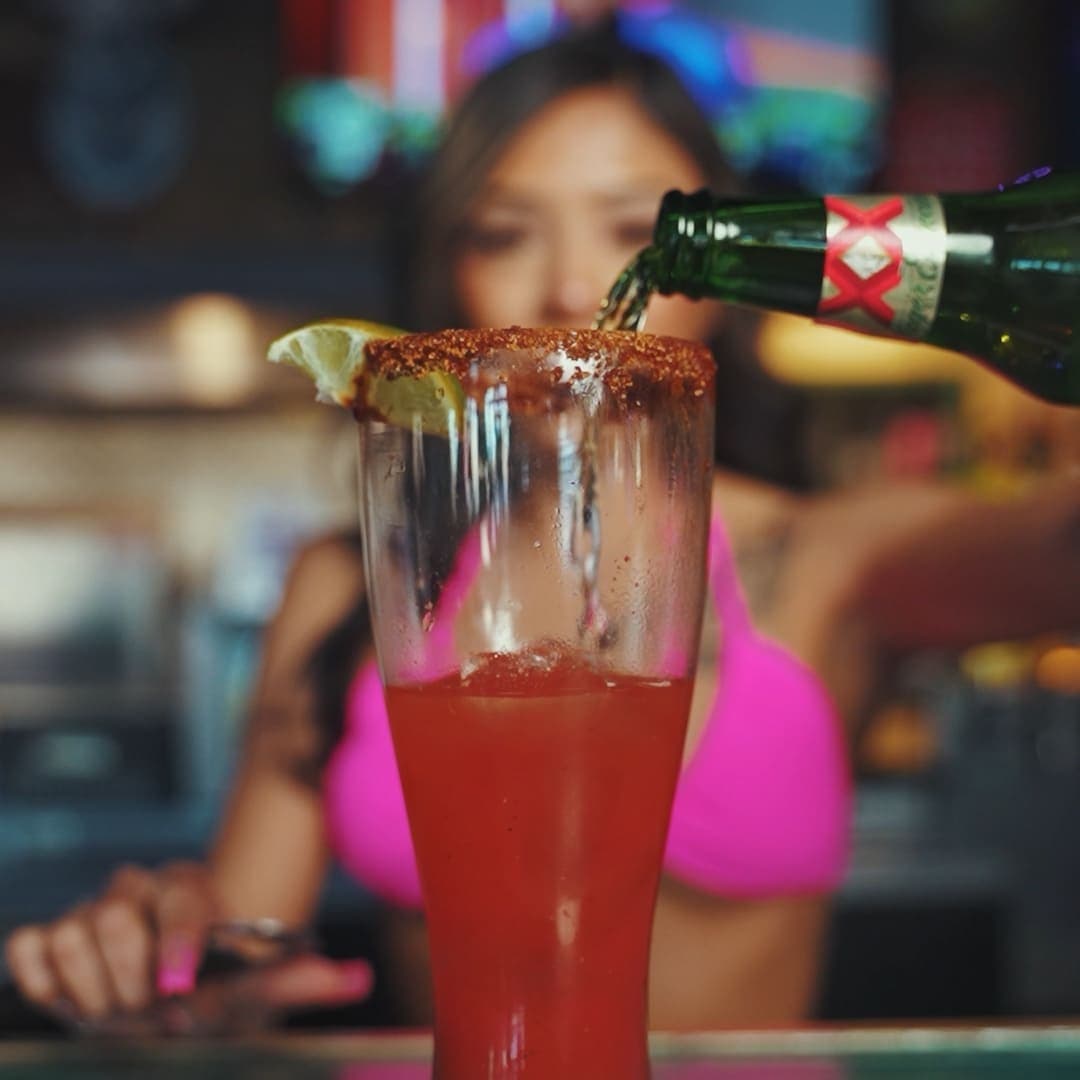Bartender pouring a drink with a chile-salt rim at Cabo Joe's