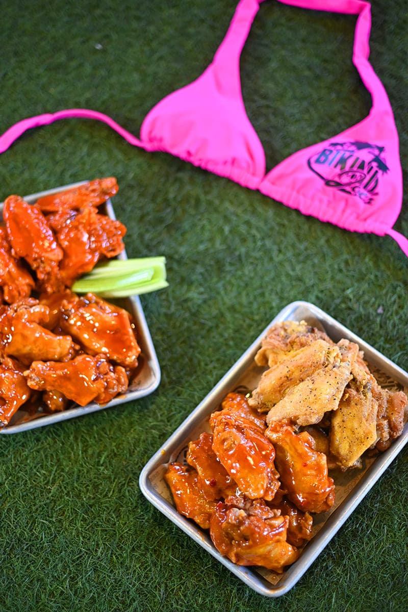 Trays of buffalo and glazed wings on grass at Cabo Joe's